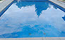 Blue Crystal Clear Swimming Pool with Rock Waterfall, Beautiful Backyard
