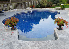 Blue Crystal Clear Swimming Pool with Rock Waterfall, Beautiful Backyard