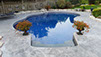 Blue Crystal Clear Swimming Pool with Rock Waterfall, Beautiful Backyard