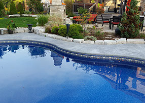 Blue Crystal Clear Swimming Pool with Rock Waterfall, Beautiful Backyard