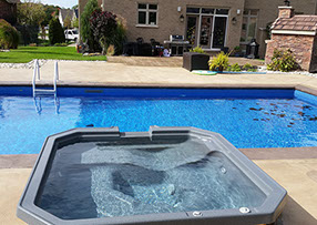 Blue Crystal Clear Swimming Pool with Rock Waterfall, Beautiful Backyard
