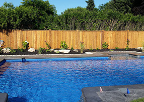 Blue Crystal Clear Swimming Pool with Rock Waterfall, Beautiful Backyard