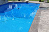 Blue Crystal Clear Swimming Pool with Rock Waterfall, Beautiful Backyard built by Flandscape in London Ontario
