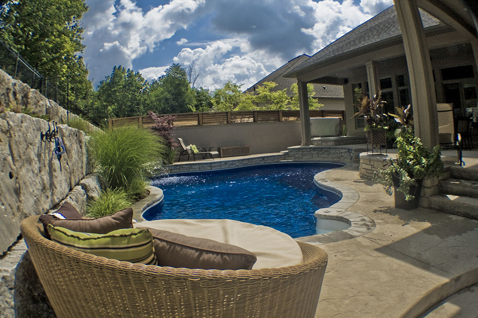 Blue Crystal Clear Swimming Pool with Rock Waterfall, Beautiful Backyard