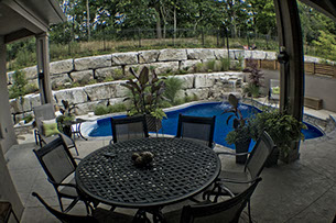 Blue Crystal Clear Swimming Pool with Rock Waterfall, Beautiful Backyard