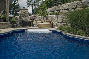 Blue Crystal Clear Swimming Pool with Rock Waterfall, Beautiful Backyard