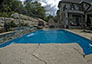 Blue Crystal Clear Swimming Pool with Rock Waterfall, Beautiful Backyard