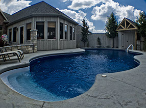 Blue Crystal Clear Swimming Pool with Rock Waterfall, Beautiful Backyard
