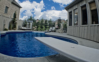 Blue Crystal Clear Swimming Pool with Rock Waterfall, Beautiful Backyard