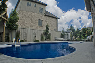 Blue Crystal Clear Swimming Pool with Rock Waterfall, Beautiful Backyard