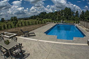 Blue Crystal Clear Swimming Pool with Rock Waterfall, Beautiful Backyard