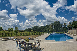 Blue Crystal Clear Swimming Pool with Rock Waterfall, Beautiful Backyard