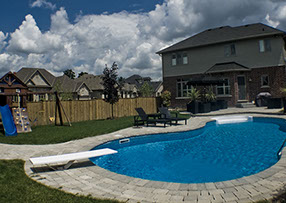 Blue Crystal Clear Swimming Pool with Rock Waterfall, Beautiful Backyard