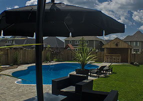 Blue Crystal Clear Swimming Pool with Rock Waterfall, Beautiful Backyard