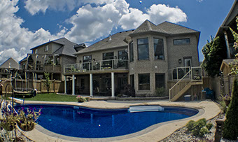 Blue Crystal Clear Swimming Pool with Rock Waterfall, Beautiful Backyard