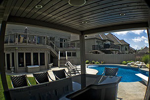 Blue Crystal Clear Swimming Pool with Rock Waterfall, Beautiful Backyard