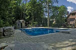 Blue Crystal Clear Swimming Pool with Rock Waterfall, Beautiful Backyard