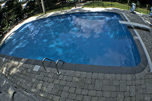 Blue Crystal Clear Swimming Pool with Rock Waterfall, Beautiful Backyard