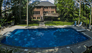 Blue Crystal Clear Swimming Pool with Rock Waterfall, Beautiful Backyard