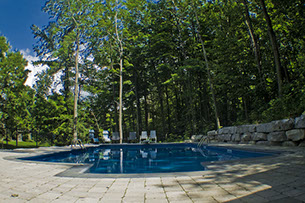 Blue Crystal Clear Swimming Pool with Rock Waterfall, Beautiful Backyard