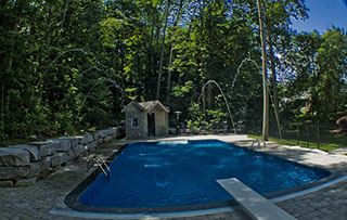 Blue Crystal Clear Swimming Pool with Rock Waterfall, Beautiful Backyard