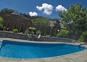Blue Crystal Clear Swimming Pool with Rock Waterfall, Beautiful Backyard