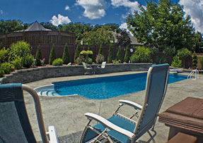 Blue Crystal Clear Swimming Pool with Rock Waterfall, Beautiful Backyard