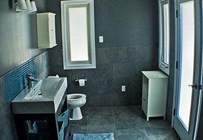 Outdoor bathroom with toilet sink and dresser all white and black