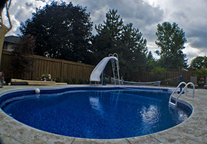 Blue Crystal Clear Swimming Pool with Rock Waterfall, Beautiful Backyard