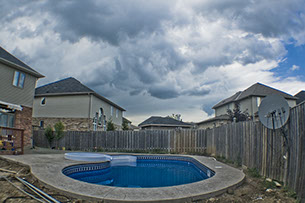 Blue Crystal Clear Swimming Pool with Rock Waterfall, Beautiful Backyard