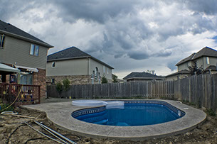 Blue Crystal Clear Swimming Pool with Rock Waterfall, Beautiful Backyard