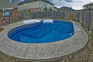 Blue Crystal Clear Swimming Pool with Rock Waterfall, Beautiful Backyard