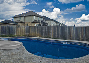 Blue Crystal Clear Swimming Pool with Rock Waterfall, Beautiful Backyard