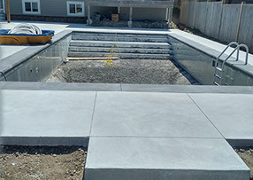 Blue Crystal Clear Swimming Pool with Rock Waterfall, Beautiful Backyard