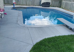 Blue Crystal Clear Swimming Pool with Rock Waterfall, Beautiful Backyard
