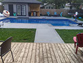 Blue Crystal Clear Swimming Pool with Rock Waterfall, Beautiful Backyard built by Flandscape in London Ontario