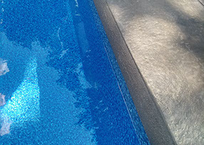 Blue Crystal Clear Swimming Pool with Rock Waterfall, Beautiful Backyard
