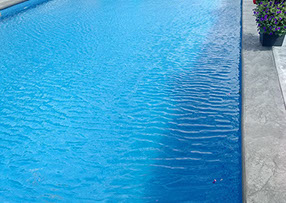 Blue Crystal Clear Swimming Pool with Rock Waterfall, Beautiful Backyard