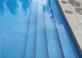 Blue Crystal Clear Swimming Pool with Rock Waterfall, Beautiful Backyard