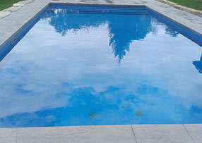 Blue Crystal Clear Swimming Pool with Rock Waterfall, Beautiful Backyard