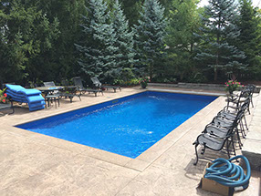 Blue Crystal Clear Swimming Pool with Rock Waterfall, Beautiful Backyard