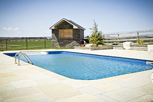 Blue Crystal Clear Swimming Pool with Rock Waterfall, Beautiful Backyard